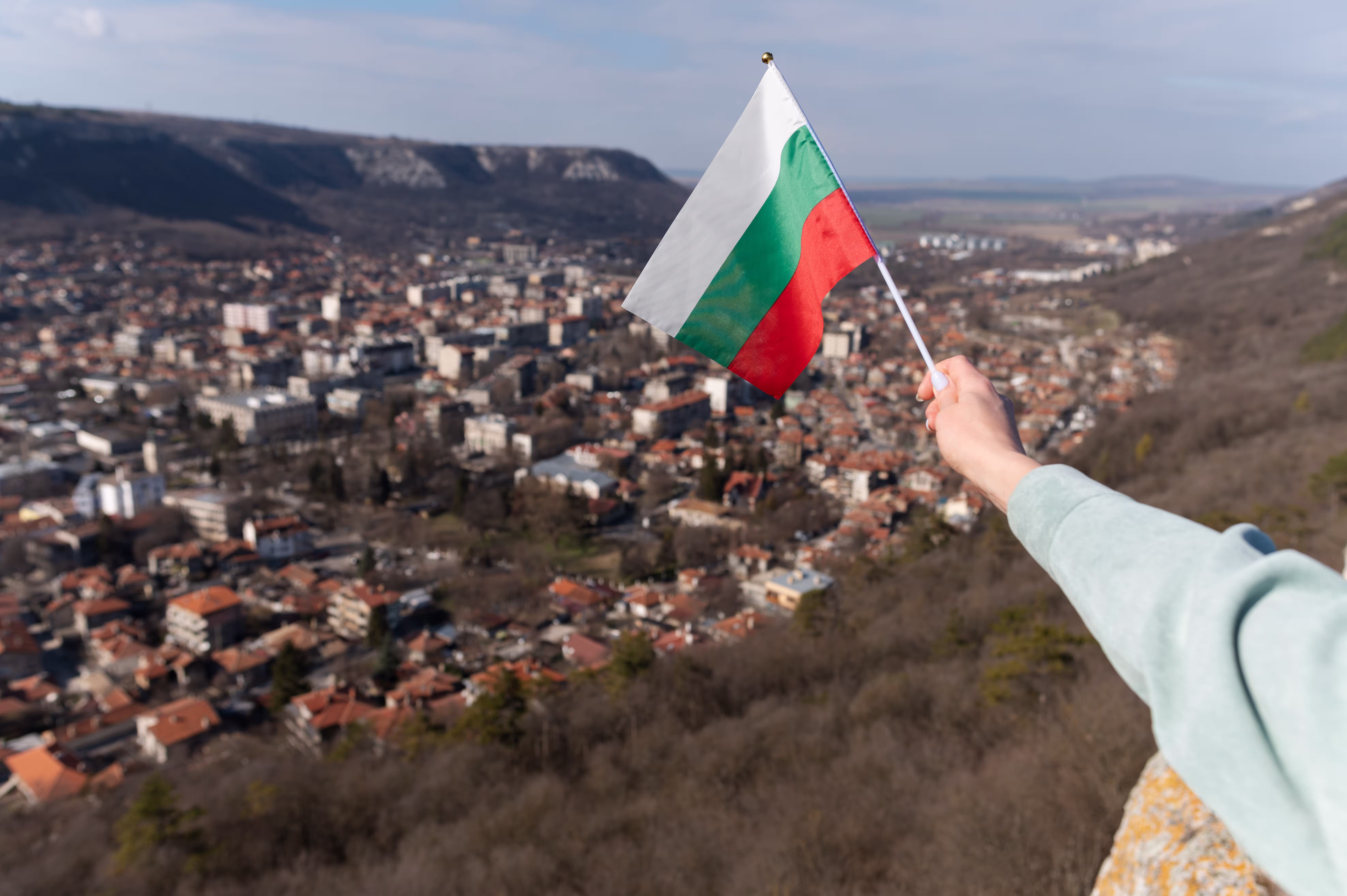 female hand holding fabric flag bulgaria