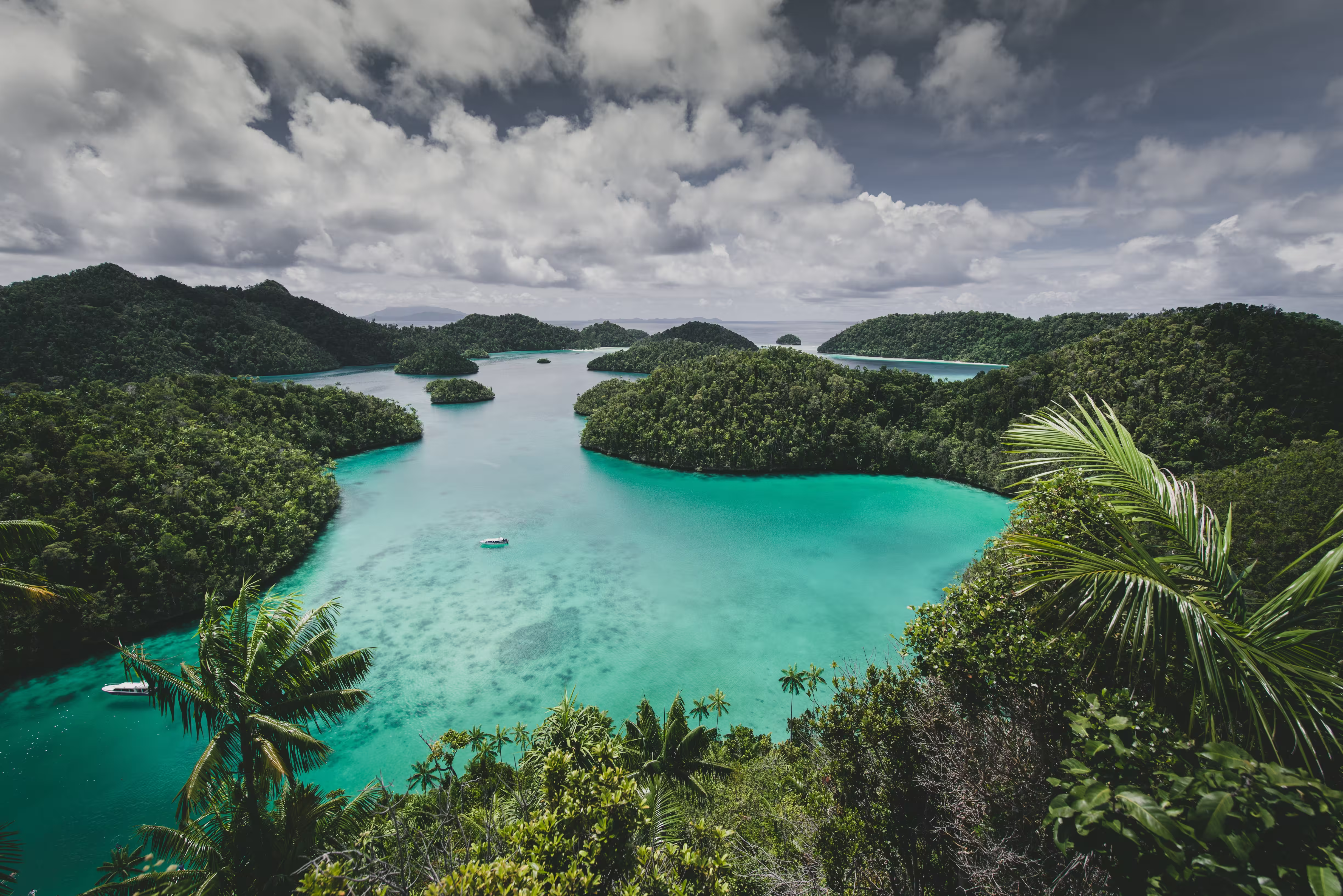 Island surrounded by sea and cloudy sky