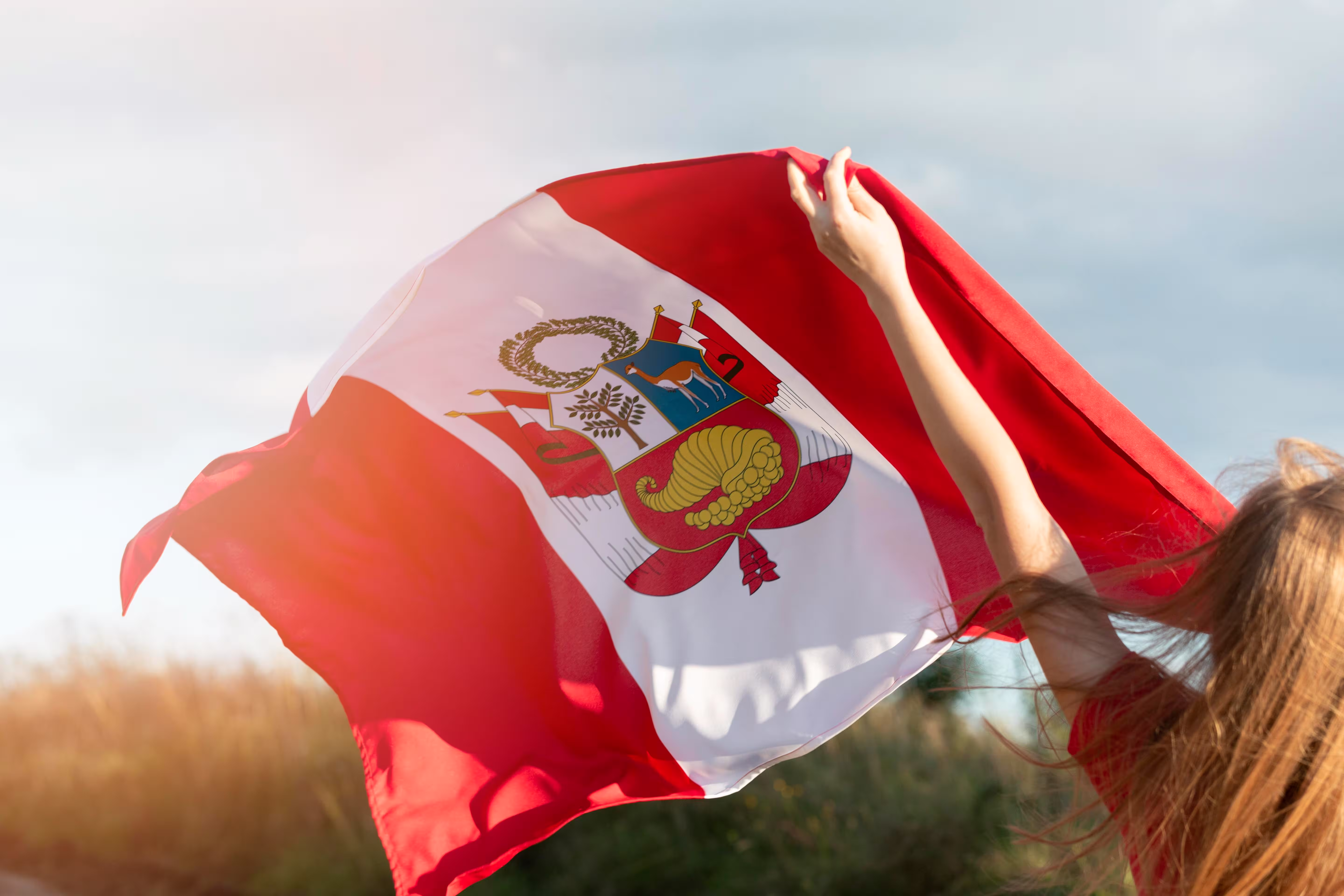 Young woman with Peru flag outdoors